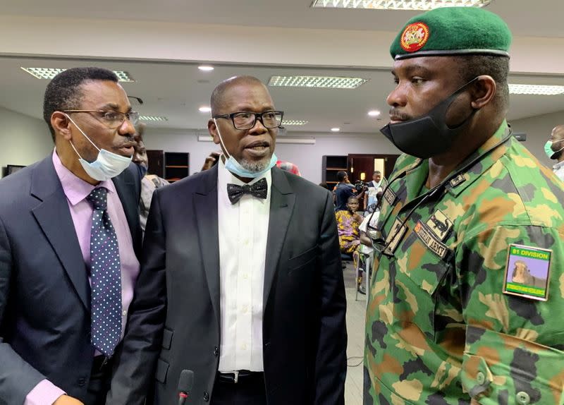 The counsel for the Nigerian Army, Akinlolu Kehinde, speaks to Brigadier General Ahmed Taiwo, during a judicial panel in Lagos