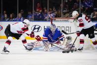 New York Rangers goaltender Igor Shesterkin (31) stops a shot by New Jersey Devils' Jimmy Vesey (16) as Tomas Tatar (90) watches during the second period of an NHL hockey game Friday, March 4, 2022, in New York. (AP Photo/Frank Franklin II)