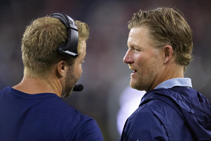 Rams coach Sean McVay (left) talks with GM Les Snead.