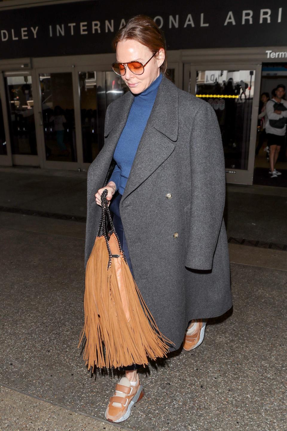 No need for an airplane blanket with a souped-up overcoat and turtleneck.