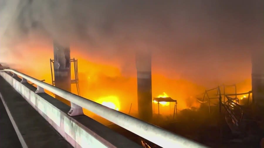 Firefighters battle a massive fire near an overpass in downtown Los Angeles on Nov. 11, 2023. (KTLA)