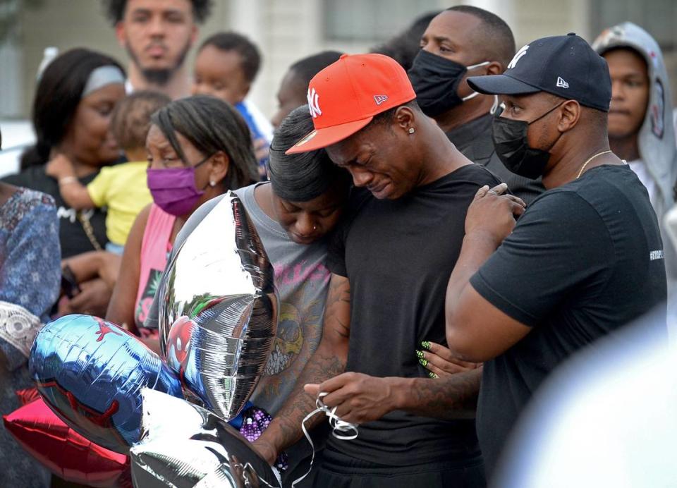 The parents of 3-year-old Asiah Figueroa are comforted by family and community members during a memorial gathering for their son on Wednesday, Sept. 8, 2021. Asiah was shot to death Sept. 7, 2021 during a drive-by shooting. Shooters fired a barrage of 150 bullets into the family’s Charlotte home.