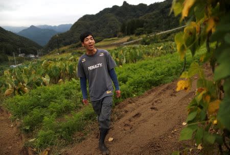 26 year-old farmer Yohka Tanaka walks at his field in Nanmoku Village, northwest of Tokyo, Japan October 12, 2017. Picture taken October 12, 2017. REUTERS/Issei Kato