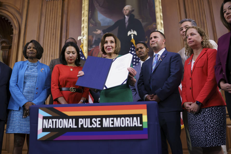 House Speaker Nancy Pelosi, D-Calif., joined by, from left, Rep. Val Demings, D-Fla., Rep. Stephanie Murphy, D-Fla., Rep. Darren Soto, D-Fla., and Rep. Debbie Wasserman Schultz, D-Fla., holds the bill to create the National Pulse Memorial to honor the victims of the 2016 mass shooting at the Pulse nightclub in Orlando, at the Capitol in Washington, Wednesday, June 16, 2021. The shooting was the deadliest attack on the LGBTQ community in U.S. history and left 49 people dead. (AP Photo/J. Scott Applewhite)