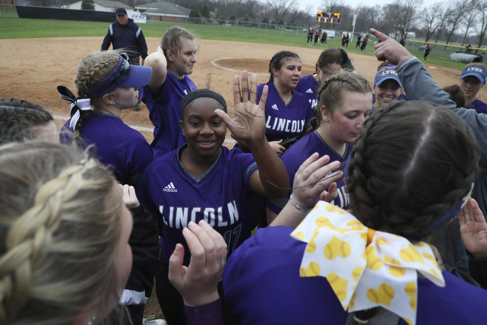 Aundrea Jenkins, center, celebrates with other Lincoln College softball players after the team defeated Cardinal Stritch University in Lincoln, Ill., on Tuesday, April 12, 2022. The historically Black college in central Illinois named after Abraham Lincoln and founded the year the former president was assassinated will close this week, months after a cyberattack that compounded enrollment struggles due to the coronavirus pandemic. (Terrence Antonio James/Chicago Tribune)/Chicago Tribune via AP)