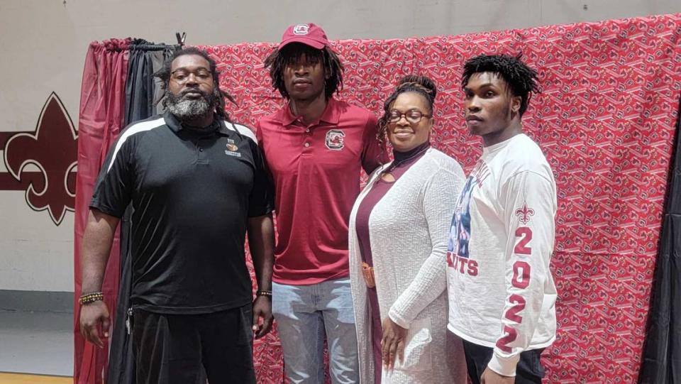 Clarendon Hall’s Kylic Horton poses for pictures with his family after he signed to play football with South Carolina on Dec. 15, 2021.
