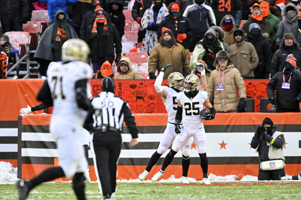 Teammates congratulate New Orleans Saints safety Daniel Sorensen (25) after he intercepted a pass intended for Cleveland Browns wide receiver David Bell during the second half of an NFL football game, Saturday, Dec. 24, 2022, in Cleveland. (AP Photo/David Richard)