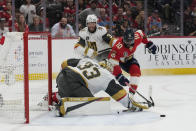 Vegas Golden Knights goaltender Adin Hill (33) defends the net from a shot by Florida Panthers left wing Anthony Duclair (10) during the second period of Game 3 of the NHL hockey Stanley Cup Finals, Thursday, June 8, 2023, in Sunrise, Fla. (AP Photo/Lynne Sladky)