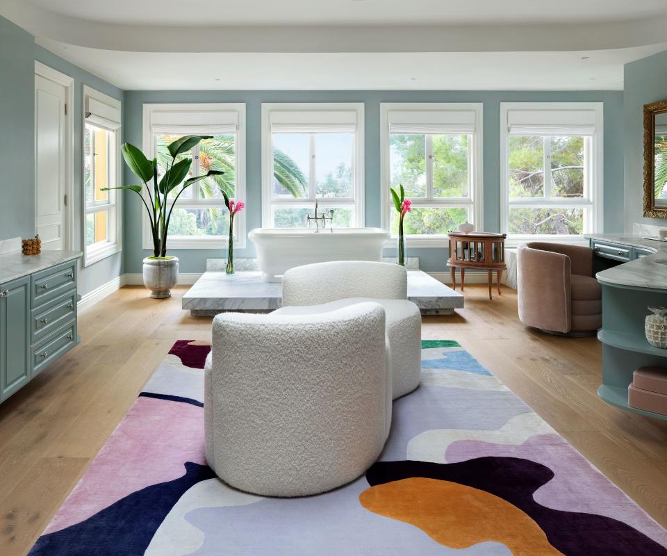 big bathroom with freestanding tub bright rug and tete a tete sofa