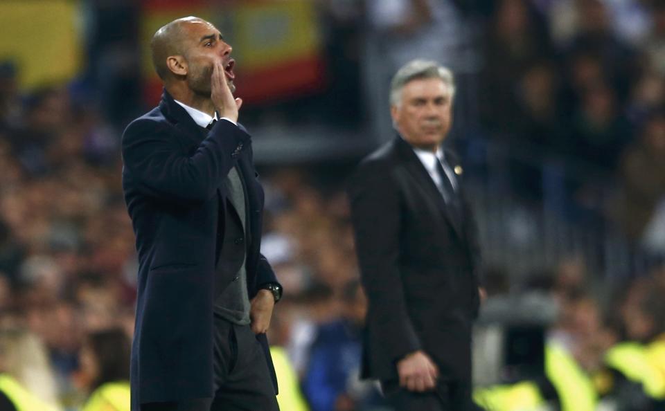 Bayern Munich's coach Guardiola reacts as Real Madrid's coach Ancelotti looks on during their Champions League semi-final first leg soccer match at Santiago Bernabeu stadium in Madrid