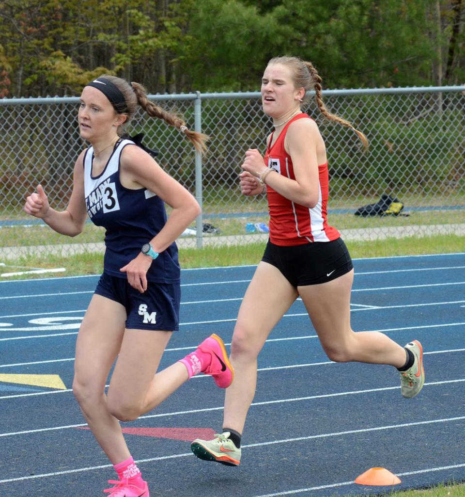 Miriam Murrell (left) runs ahead of Madalyn Agren (right) in the 1600-meter run during the MHSAA Region 31-4 track meet on Friday, May 19 in Indian River, Mich.
