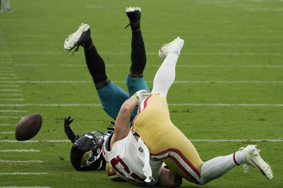 Jacksonville Jaguars cornerback Darious Williams, left, breaks up a pass intended for San Francisco 49ers running back Christian McCaffrey, right, during the second half of an NFL football game, Sunday, Nov. 12, 2023, in Jacksonville, Fla. (AP Photo/John Raoux)