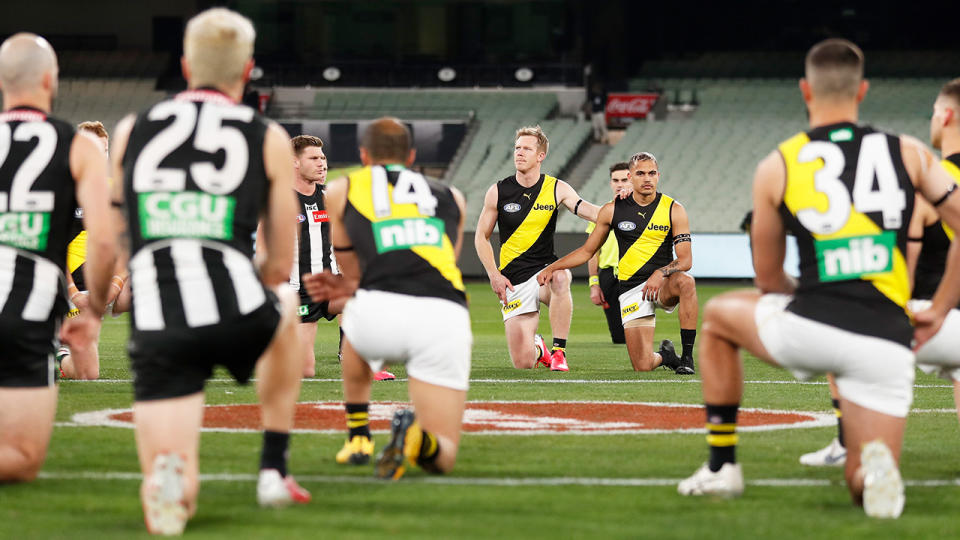 AFL players, pictured here taking a knee to support the Black Lives Matter movement.