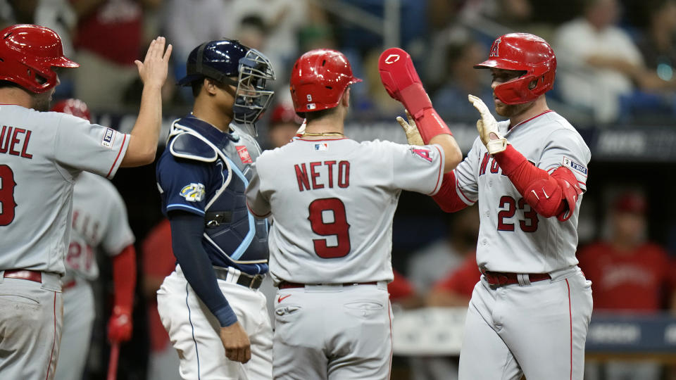 Los Angeles Angels' Brandon Drury (23) celebrates his three-run home run off Tampa Bay Rays starting pitcher Aaron Civale with Zach Neto (9) and Nolan Schanuel (18) during the second inning of a baseball game Wednesday, Sept. 20, 2023, in St. Petersburg, Fla. (AP Photo/Chris O'Meara)