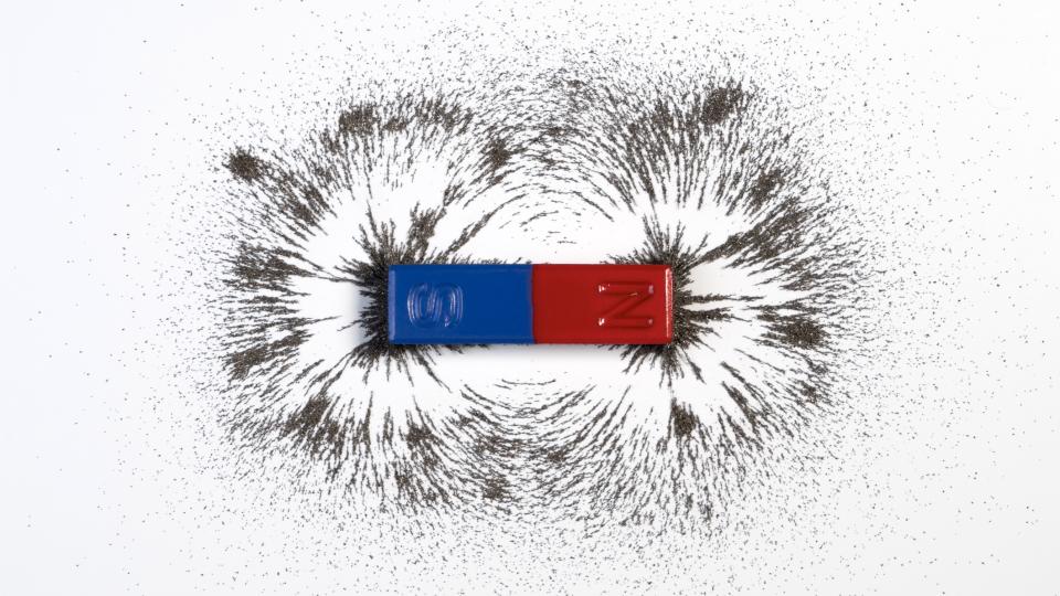  Red and blue bar magnet or physics magnetic with iron powder magnetic field on white background. 