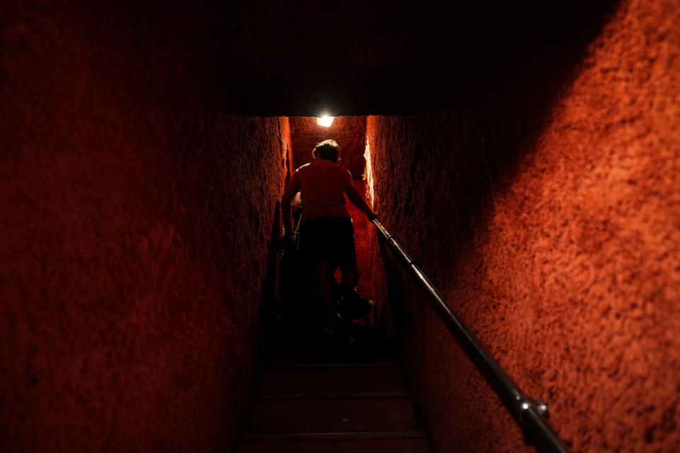 A man walks up a narrow staircase leading to a bar at the Golden Gai in the Shinjuku district of Tokyo, July 26, 2019. (AP Photo/Jae C. Hong)