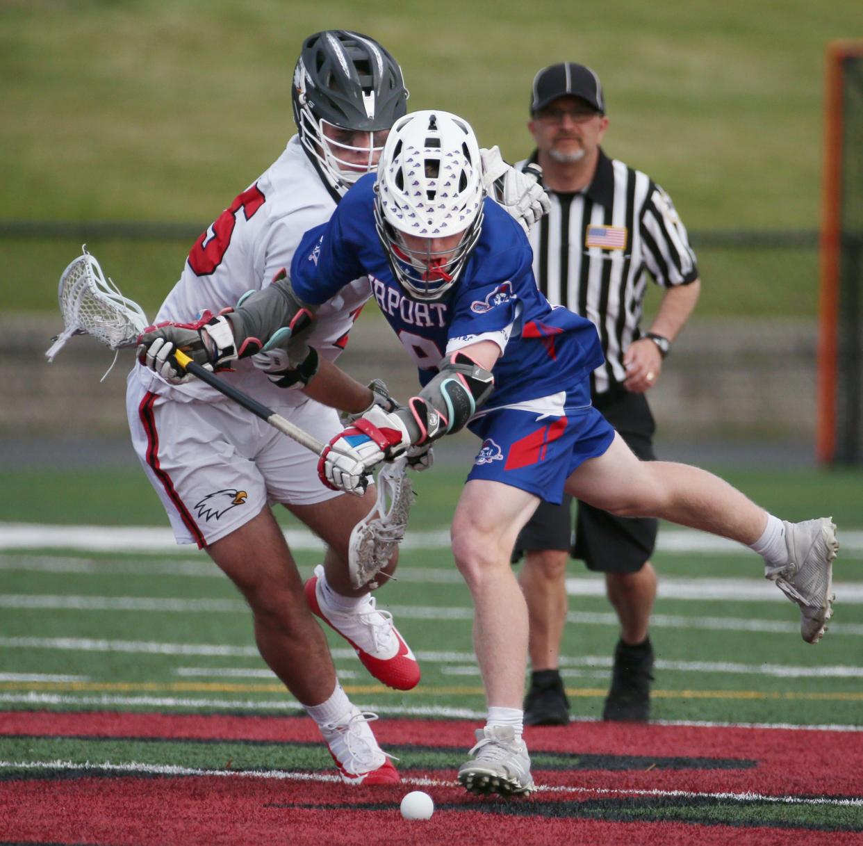 Fairport's Mitchell Monte gets a step on Penfield's Ethan Hamilton as they battle for the ball at midfield.
