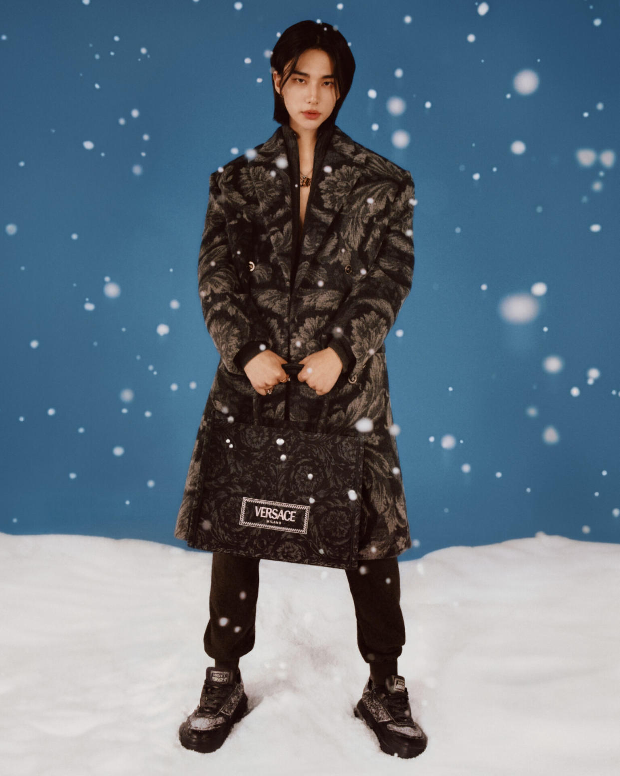 Hyunjin wears Barocco jacquard cashmere coat; cashmere sweatpants; Barocco jacquard Odissea sneakers; Athena tote bag (Picture: Versace, Photography: Angelo Pennetta)