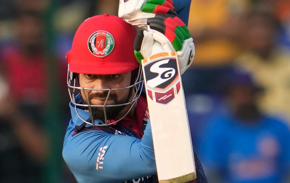 Afghanistan's Rashid Khan hits a boundary during the ICC Men's Cricket World Cup match between Afghanistan and England