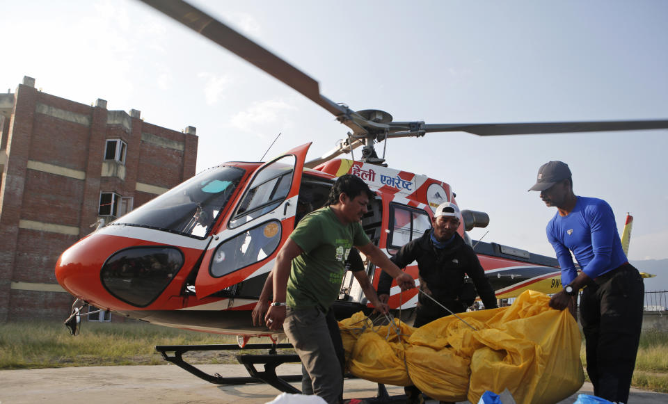 FILE - The bodies of Indian climbers are unloaded from a helicopter in Kathmandu, Nepal, on May 28, 2017, after being retrieved from Mount Everest by rescuers. The massive hunt for the Titan submersible that imploded deep in the North Atlantic has refocused attention on whether wealthy risktakers should pay for emergency search and rescue efforts, a conundrum that comes as the world's wealthiest seek out singular adventures atop peaks, under the ocean and in space. (AP Photo/Niranjan Shrestha, File)