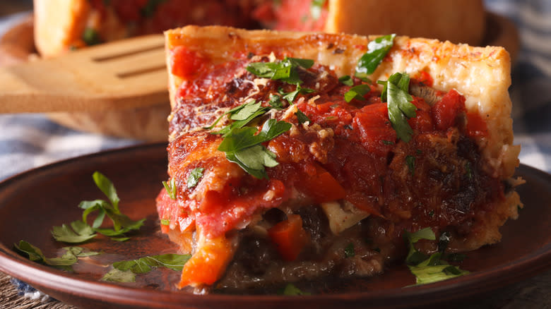 Slice of deep dish pizza