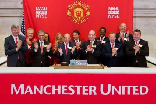Manchester United Executives as they ring the Opening Bell at the New York Stock Exchange in New York City. Manchester United shares barely treaded water in debut trade in New York Friday even after underwriters slashed the IPO price amid doubts