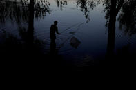 A man fishes at Natalka Park in Kyiv, Ukraine, Tuesday, June 7, 2022. (AP Photo/Natacha Pisarenko)