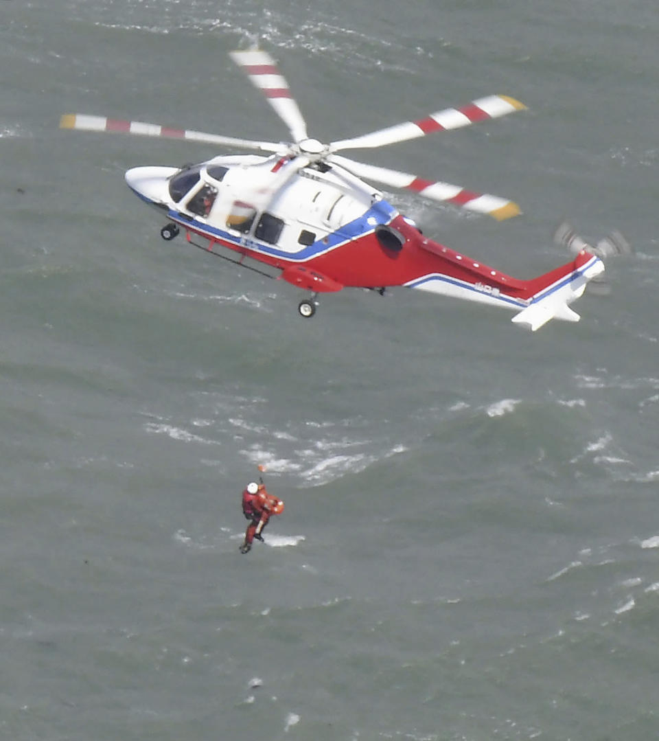 A rescue operation is conducted as a South Korean tanker capsized off Shimonoseki, Yamaguchi prefecture, southwestern Japan Wednesday, March 20, 2024. The coast guard said it received a distress call from the Keoyoung Sun chemical tanker, saying that it was tilting while taking refuge near Japan's Mutsure Island due to rough weather. (Kyodo News via AP)