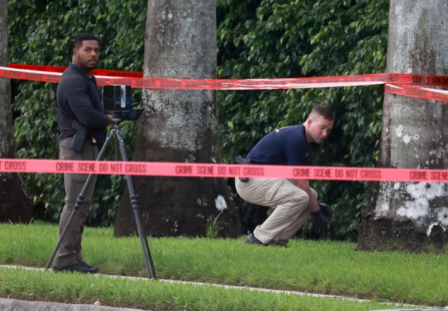 Law enforcement personnel investigate the area around Trump International Golf Club after an apparent assassination attempt of former President Donald Trump on Sunday.