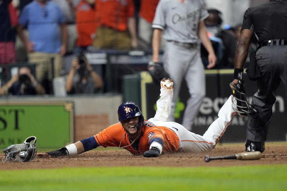 Houston Astros' Yuli Gurriel scores the game-winning run against the Chicago White Sox during the ninth inning of a baseball game Friday, June 18, 2021, in Houston. The Astros won 2-1. (AP Photo/David J. Phillip)