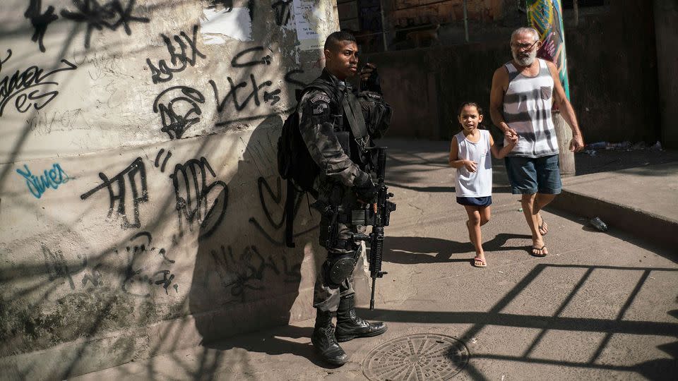 An officer takes a position during a police operation against drug traffickers at the Jacarezinho slum in Rio de Janeiro. Photo: AP