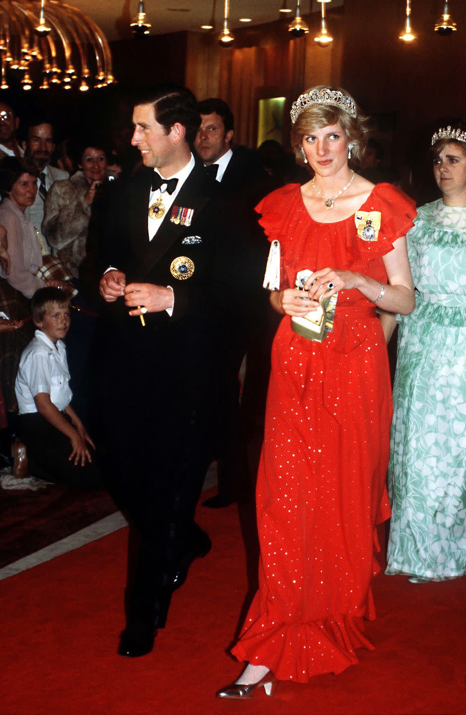 <p>That evening, the couple attends a state reception in Hobart, where Diana sports a Bruce Oldfield gown and the Spencer family tiara (<a href="https://www.elle.com/culture/movies-tv/a34692017/princess-diana-wedding-dress-explained-the-crown/" rel="nofollow noopener" target="_blank" data-ylk="slk:the very one she wore on her wedding day;elm:context_link;itc:0;sec:content-canvas" class="link ">the very one she wore on her wedding day</a>).<br></p>