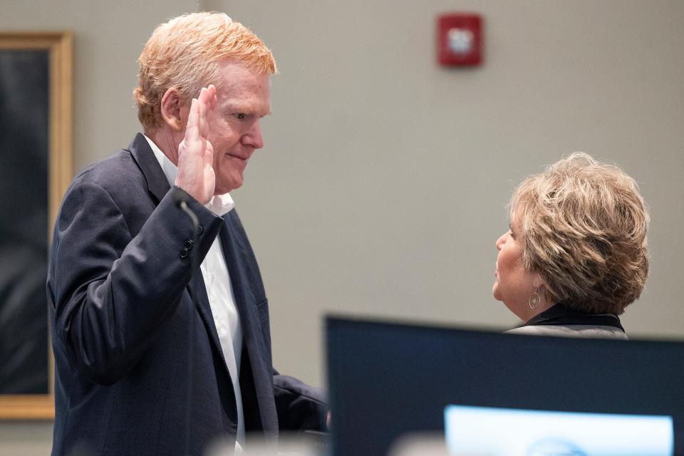 Alex Murdaugh swears to tell the truth before he takes the stand during his trial for murder at the Colleton County Courthouse on Thursday, Feb. 23, 2023, in Walterboro, S.C. Clerk of Court Becky Hill holds the Bible.