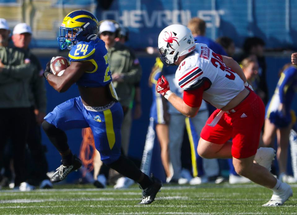 Richmond's Tristan Wheeler *right) chases Delaware running back Kyron Cumby in the first quarter of Richmond's 21-13 win at Delaware Stadium, Saturday, Nov. 12, 2022.