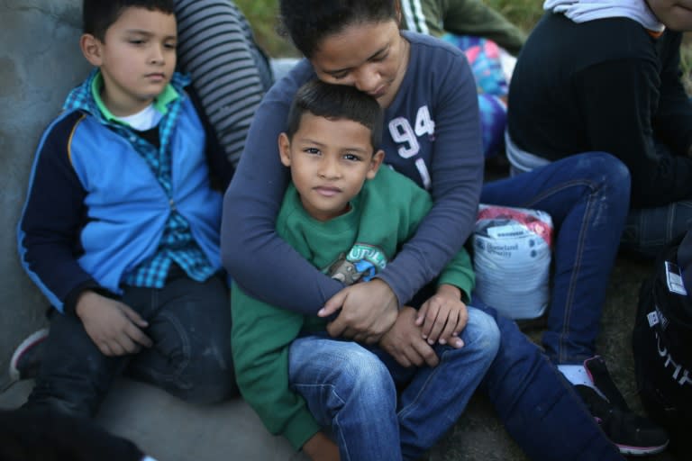 A Honduran mother holds her son, after she turned her family in to US Border Patrol agents near Rio Grande City, Texas