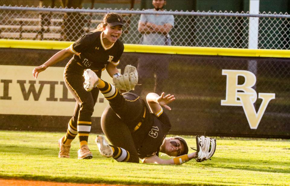 Bishop Verot's Lillie Layne made a diving catch for the out in Center field. Her teammate, Payton Teeter, celebrates. Action from the Bishop Verot vs. Academy of the Holy Names  in a Region 3A-3 quarterfinal softball game, May 11, 2022. 
