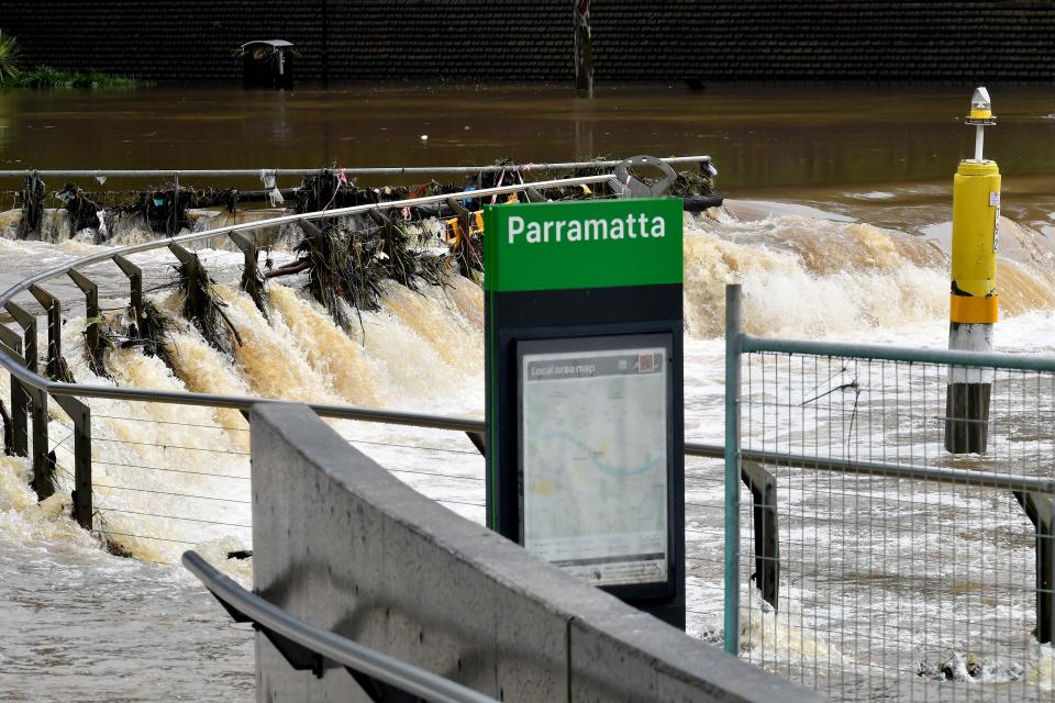 A sign is seen on the banks of the Parramatta river on March 3, 2022, as Sydney faces its worst flooding after record rainfall caused its largest dam to overflow and as deluges prompted mandatory mass evacuation from the low-lying areas. (Photo by SAEED KHAN / AFP) (Photo by SAEED KHAN/AFP via Getty Images)