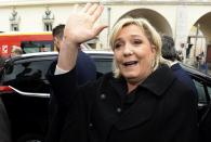 Far right leader and presidential candidate Marine Le Pen waves as she arrives to pay homage to the 86 victims of an attack last year, Monday Feb. 13, 2017 in Nice, southern France. Le Pen is zeroing in on two of her top priorities, security and immigration, in a visit to southeastern France. (AP Photo/Christian Alminana)