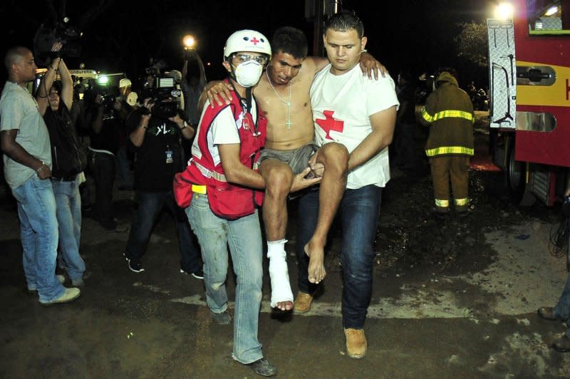 Injured inmates are evacuated after a fire broke out at a prison in the town of Comayagua, Honduras, on February 15, 2012. File Photo by Gustavo Amador/EPA