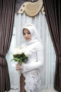 A wedding photo of the bride of a Lion Air flight JT610 victim, who carried on the celebration despite the absence of the groom, in Bangka, Bangka Belitong Province, Indonesia November 11, 2018 in this picture obtained from social media on November 16, 2018. LALA INDRA PERMANA/via REUTERS