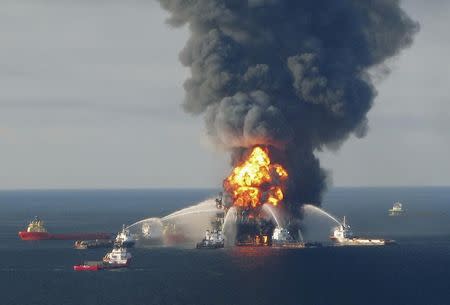 Fire boat response crews battle the blazing remnants of the offshore oil rig Deepwater Horizon, off Louisiana, in this April 21, 2010 file handout image. REUTERS/U.S. Coast Guard/Files/Handout