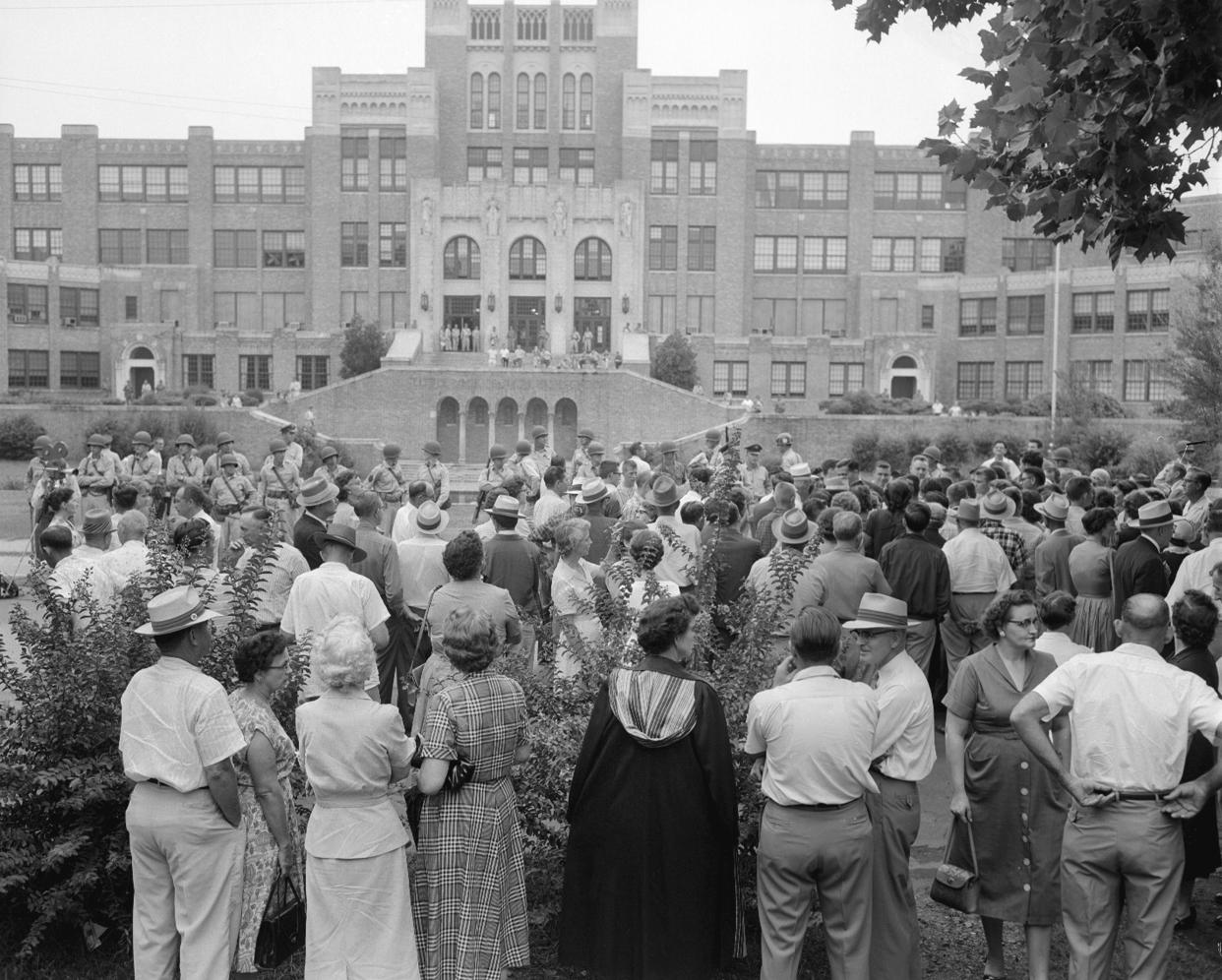 FILE - Only white students enter Central High School in Little Rock, Ark., on Sept. 5, 1957. The school was under integration orders from U.S. District Judge Ronald N. Davies. The day before nine Black students were refused admittance to the school by Arkansas National Guardsmen. The military men were ordered by Arkansas Gov. Orval Faubus to surround the school and prevent Black students from entering the grounds. (AP Photo/William P Straeter, File)