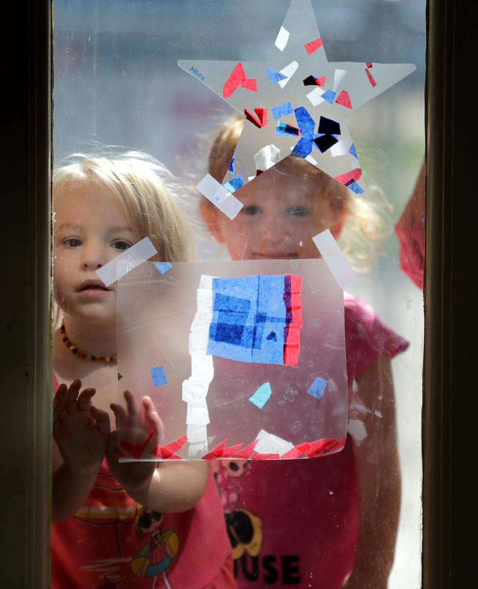 Norah Frank, left, and Remi Vander Zanden wait at the front doors after an outdoor play period at Community Child Care Center on Monday, July 13, 2020, in Kimberly Wis.