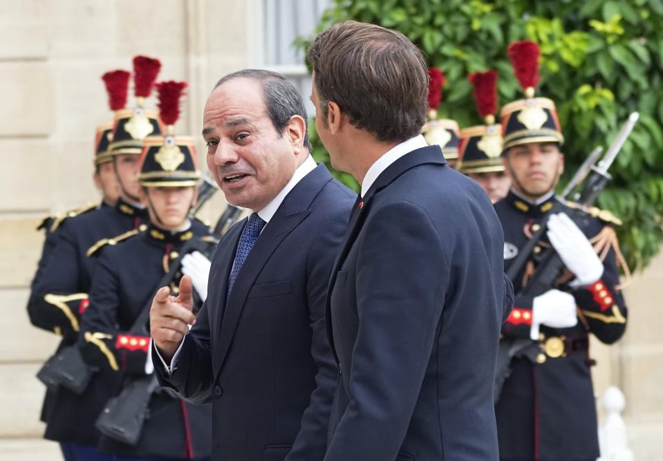 Egyptian President Abdel Fattah el-Sissi, left, is welcomed by French President Emmanuel Macron at the Elysee Palace, Friday, July 22, 2022. (AP Photo/Michel Euler)