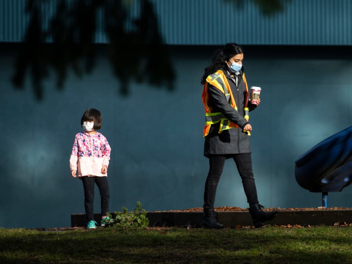 A staff member at Gray Elementary School is pictured during recess in Delta, British Columbia on Thursday, Jan. 13, 2022.  (Ben Nelms/CBC - image credit)