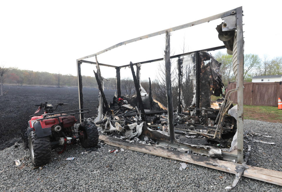 An outdoor shed and ATV on Hazen Lane in Congers, were destroyed after a massive brush fire, pictured April 15, 2023. 