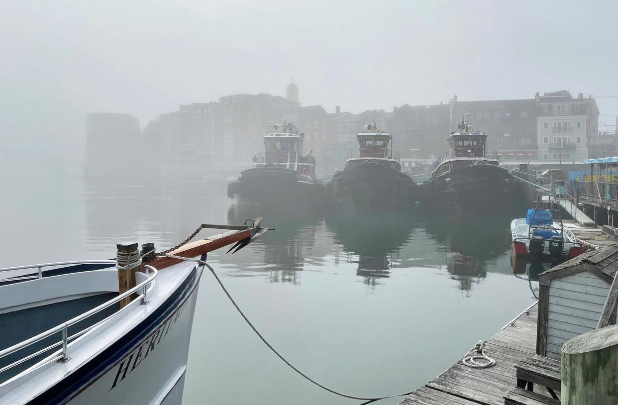 Three Moran tugboats known for guiding huge ships into port rest at their station wait for the next big job in Portsmouth, New Hampshire.