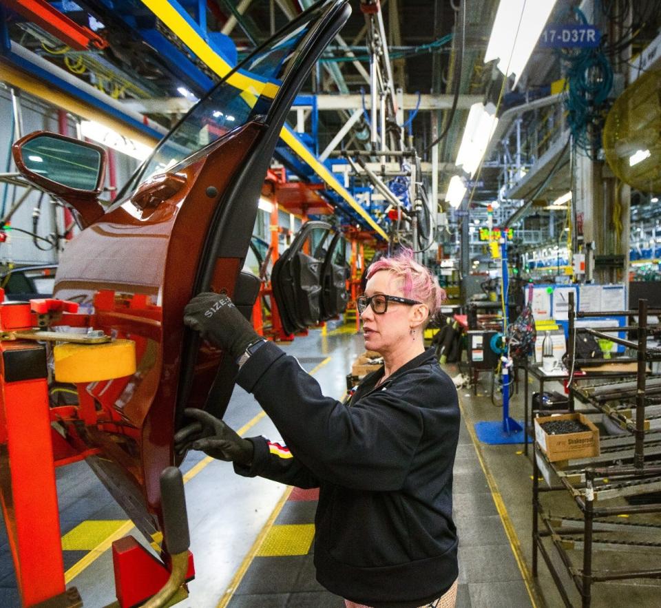 General Motors employees work on the assembly line Friday, April 26, 2019 at Fairfax Assembly & Stamping Plant in Kansas City, Kansas. The Fairfax facility produces the Cadillac XT4 and Chevrolet Malibu.