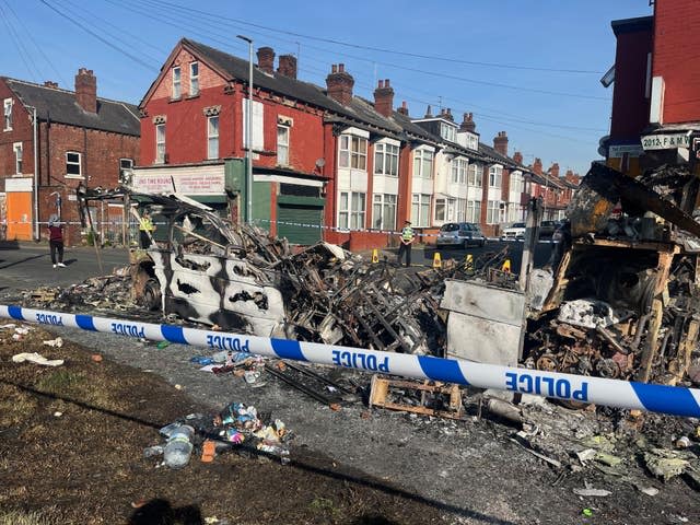 A burnt out car in the Leeds suburb of Harehills