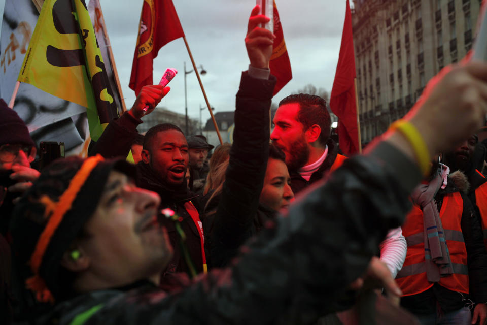 French union members and workers demonstrate after 22 days on a strike against pension reform plans, in Paris, Thursday, Dec. 26, 2019. France's punishing transportation troubles may ease up slightly over Christmas, but unions plan renewed strikes and protests in January to resist government plans to raise the retirement age to 64. (AP Photo/Thibault Camus)